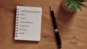 An agenda and a pen on a wooden table