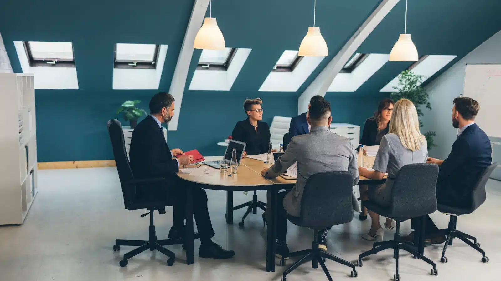 A group of people around a table holding a meeting