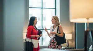 Two Women Talking Before a Meeting